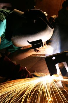 A craftsman stick welding on pipe