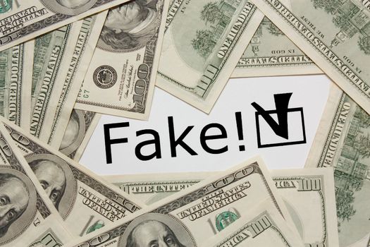 Dollars on white background with text 'Fake!'