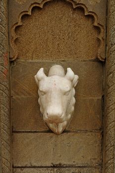 Nandi marble face on brown arc wall .poona, Maharashtra, India