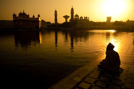 Sikh pilgrims sitting beside the holy pool,Golden Temple,Amritsar,Punjab state,India,Asia