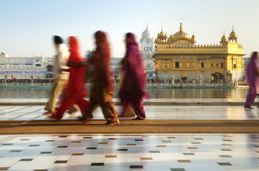 Group of Sikh pilgrims walking by the holy pool,Golden Temple,Amritsar,Punjab state,India,Asia