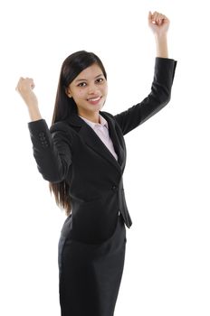 Portrait of excited business woman celebrating success over white background