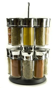 different spices rolling set in glass jars on wooden mat