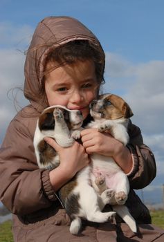 sad little girl and her purebred puppies jack russel terrier