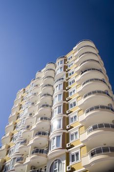 high modern residential building on a background blue sky