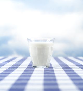 Glass of Milk towards blue sky