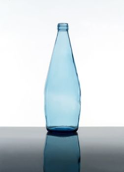 Blue bottle still life on white background