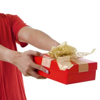 Young man giving a gift box on white background