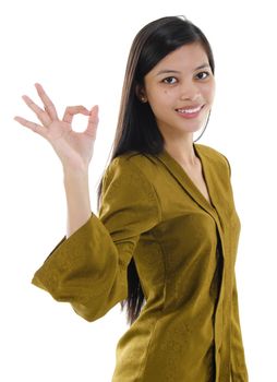 Asian female okay hand sign with great smile.