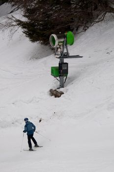 skier passing a snowgun/snow cannon in Montafon, Austria