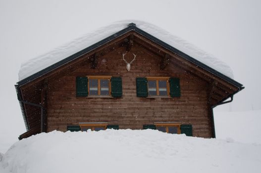 Wooden skiing hut covered with a lot of fresh snow in Montafon, Austria