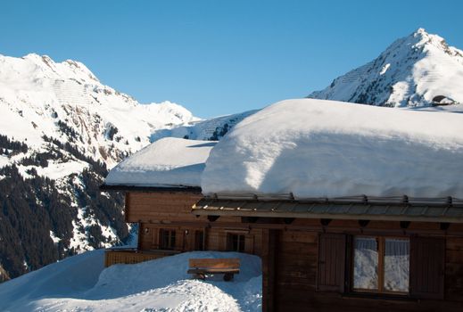 Small wooden huts covered with a lot of fresh snow in Montafon, Austria