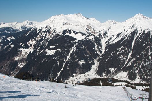 cabins of a cable car lift in front of mountains in Montafon, Austria