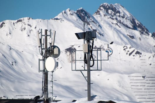 Communication tower with lifecam, satellite dishes and aerials in skiing resort in Montafon, Austria