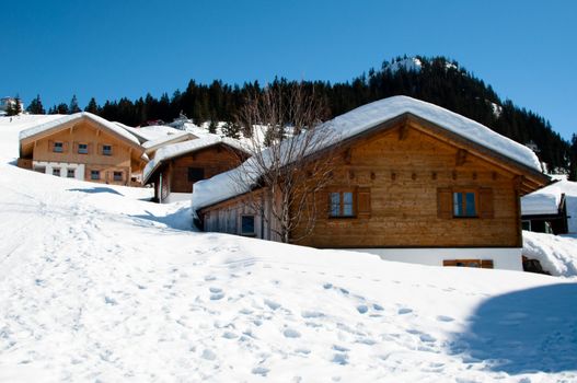 Wooden skiing huts covered with a lot of fresh snow in Montafon, Austria