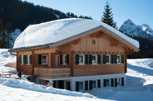 Wooden hut covered with a lot of fresh snow in Montafon, Austria