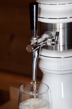 closeup of fresh beer pouring from a tap