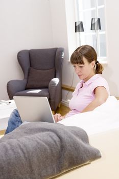 Woman with her computer in the sofa