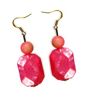 Earrings made of plastic and glass pink isolated on a white background. Collage.