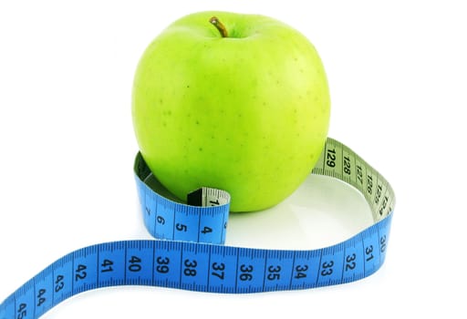 Bright green apple and measuring tape isolated on a white background