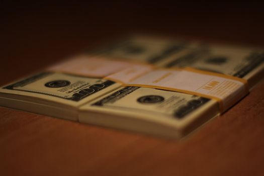 Stacks of hundred dollar bills close up.