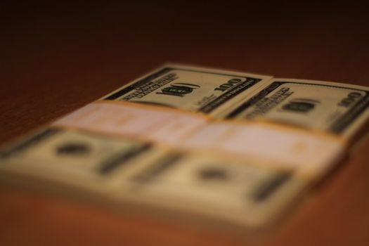 Stacks of hundred dollar bills close up.