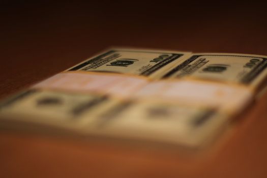 Stacks of hundred dollar bills close up.