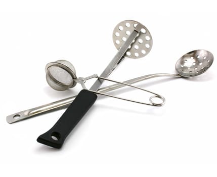 Two perforated spoons and tea strainer isolated on a white background