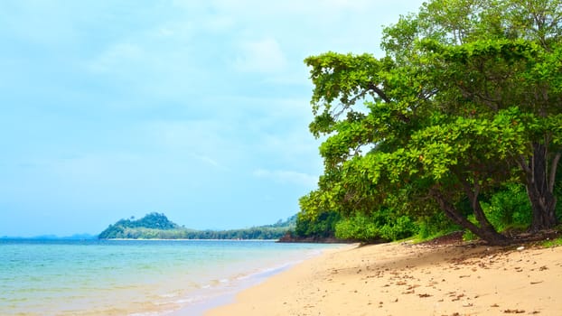 sunny beach and island on horizon, Thailand