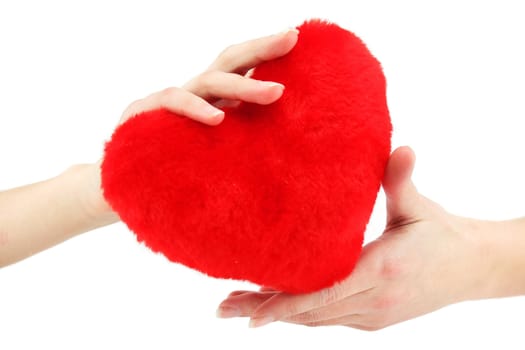 Close-up of red wooden heart in female hands showing it (isolated)