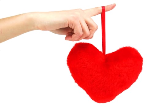 Close-up of red wooden heart hanging down from female hand (isolated)