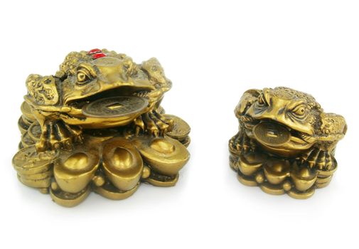 Statuette of two frogs with chinks made of bronze isolated on a white background