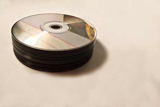 Heap of CD on isolated background with tints of yellow.