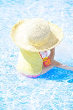 fashion toddler girl playing in swimming pool