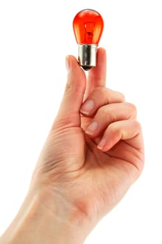 Female hand holds medical orange light bulb isolated on a white background