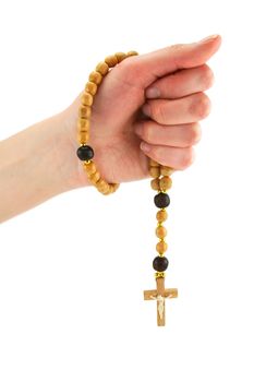 Female hand holds wooden rosary isolated on a white background