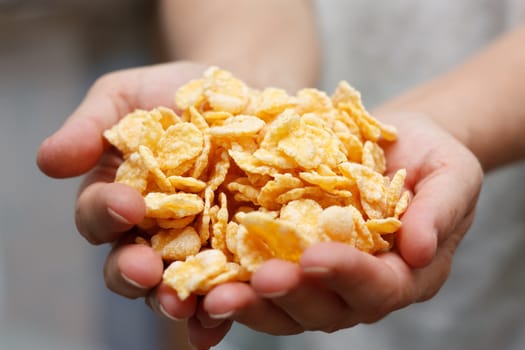 corn flakes in hands.