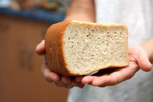 The bread in two hands.
