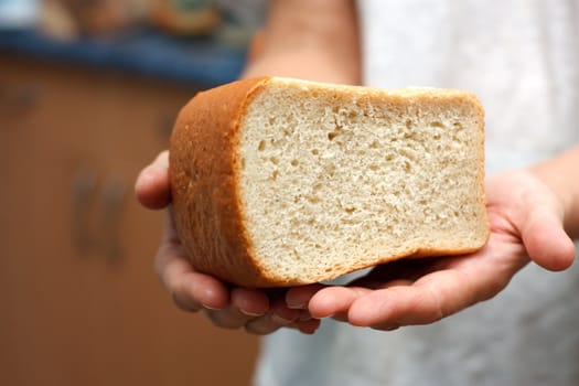 The bread in two hands.