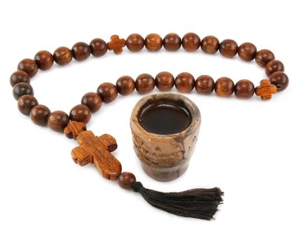 Wood rosary and ancient glass isolated on a white background