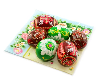 Group of painted Easter eggs on colored napkin isolated on a white background