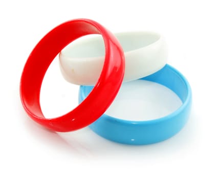 Three colored plastic bracelets isolated on a white background