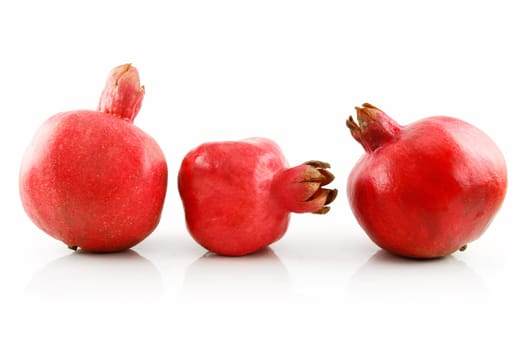 Three Ripe Pomegranates Fruits in Raw Isolated on White Background