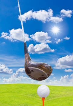 golf ball and driver on green grass