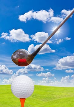 golf ball and driver on green grass