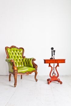 vintage luxury armchair and telephone in white room
