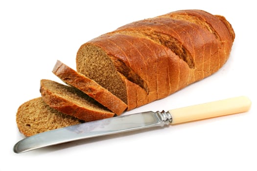 Whole wheat bread and table knife isolated on a white background