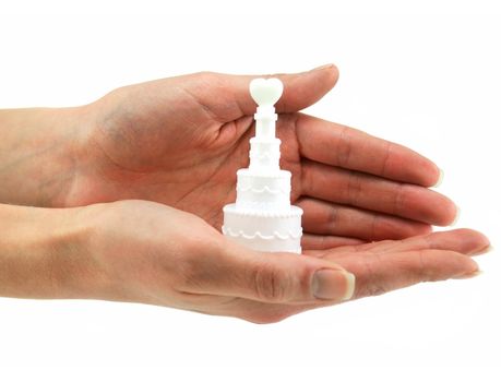 Female hands holds small wedding cake isolated on a white background