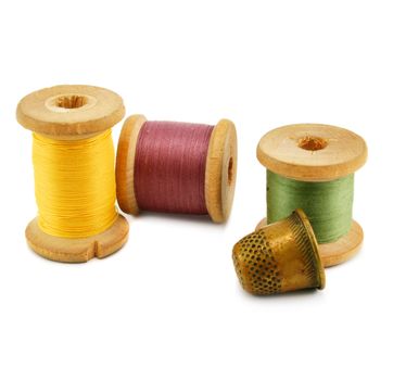 Spools of thread and thimble isolated on a white background