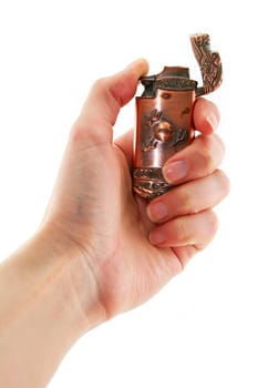 Female hand holds old bronze gas lighter isolated on a white background